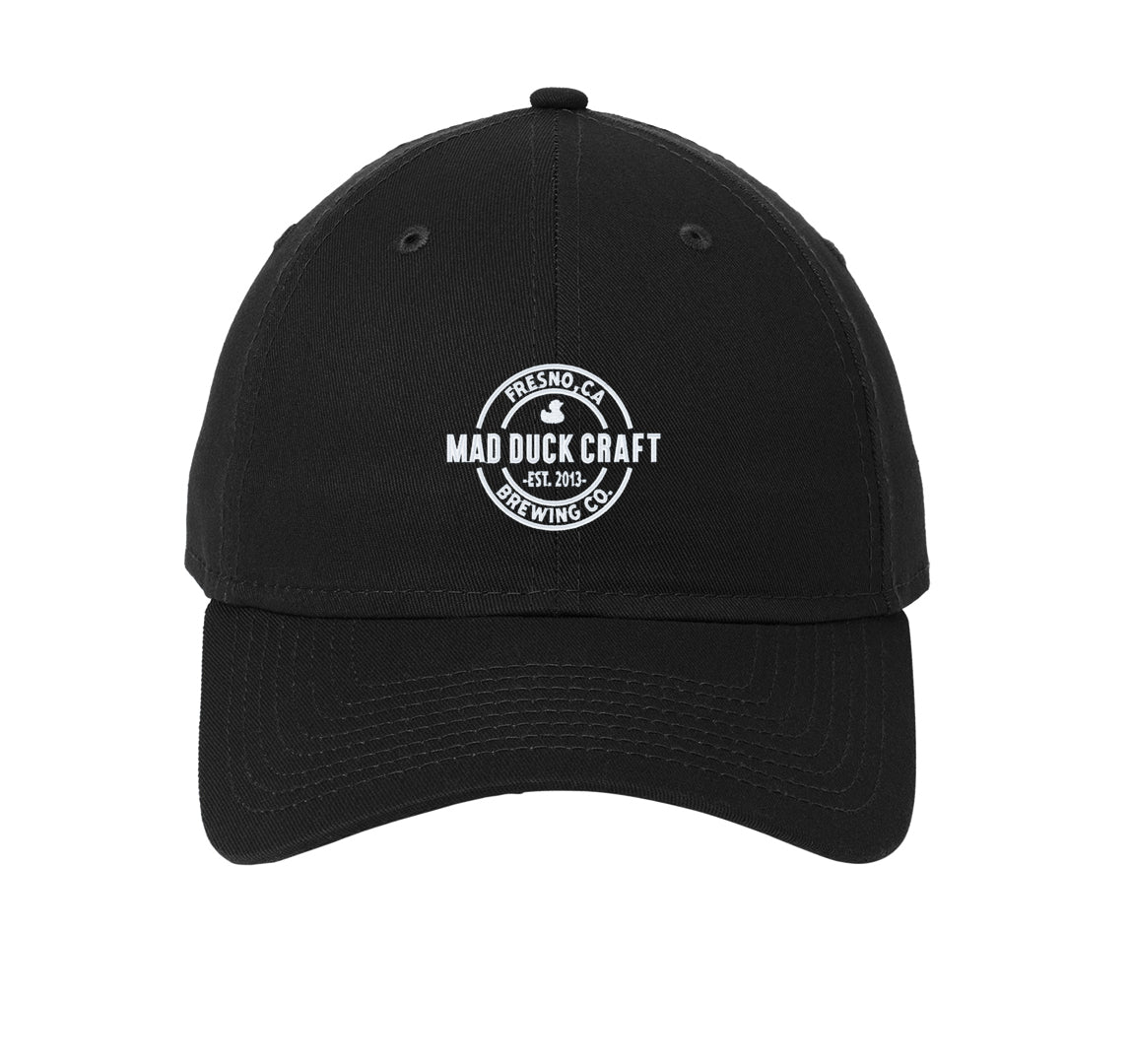 Black unstructured New Era dad cap with white embroidered Mad Duck Craft Brewing logo on the front.