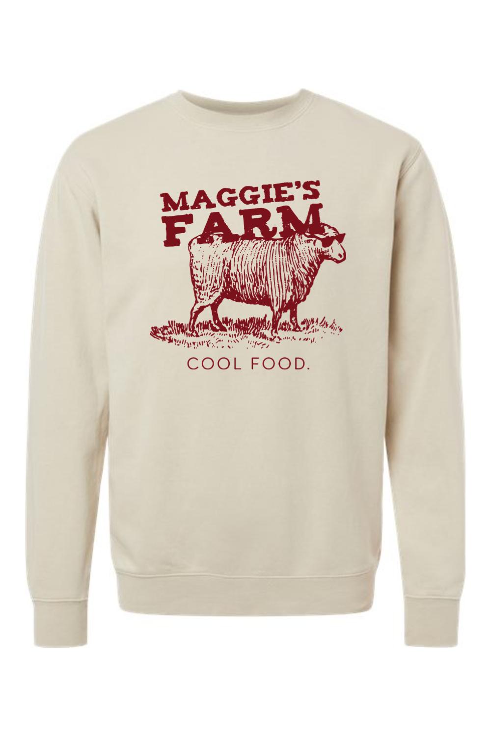 Beige pigment-dyed crewneck sweatshirt featuring a red graphic of a sheep wearing sunglasses and the text Maggie's Farm.