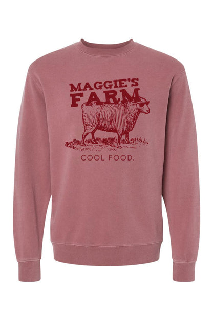 Dusty rose pigment-dyed crewneck sweatshirt featuring a graphic of a sheep in sunglasses and Maggie's Farm text.