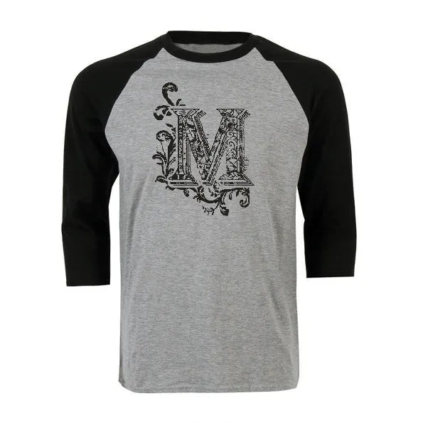 Grey and black unisex raglan baseball shirt featuring a decorative black letter M graphic on the chest.