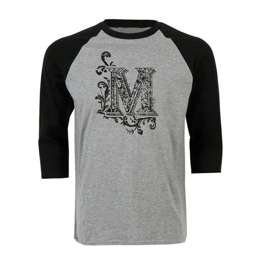 Grey and black unisex raglan baseball shirt featuring a decorative black letter M graphic on the chest.