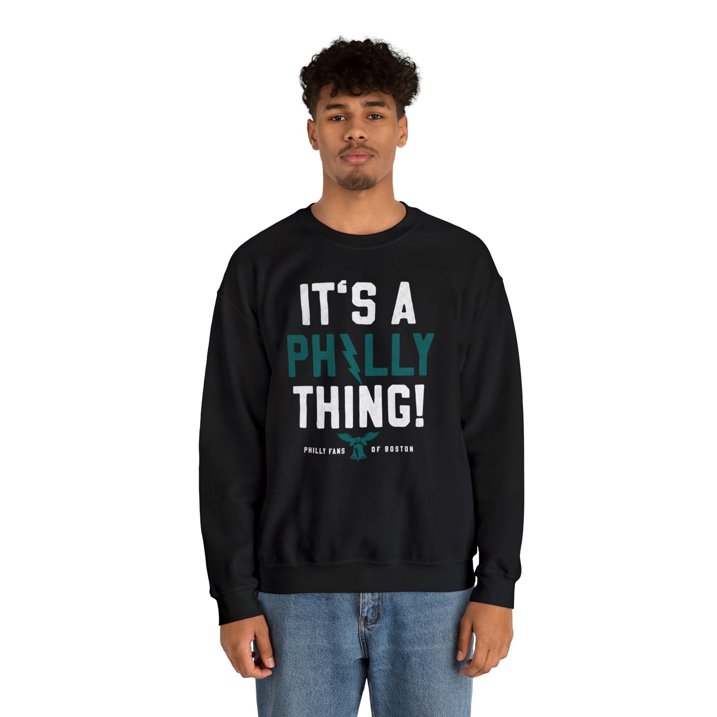 Man wearing a black heavy blend crewneck sweatshirt with It's A Philly Thing graphic print in white and teal.