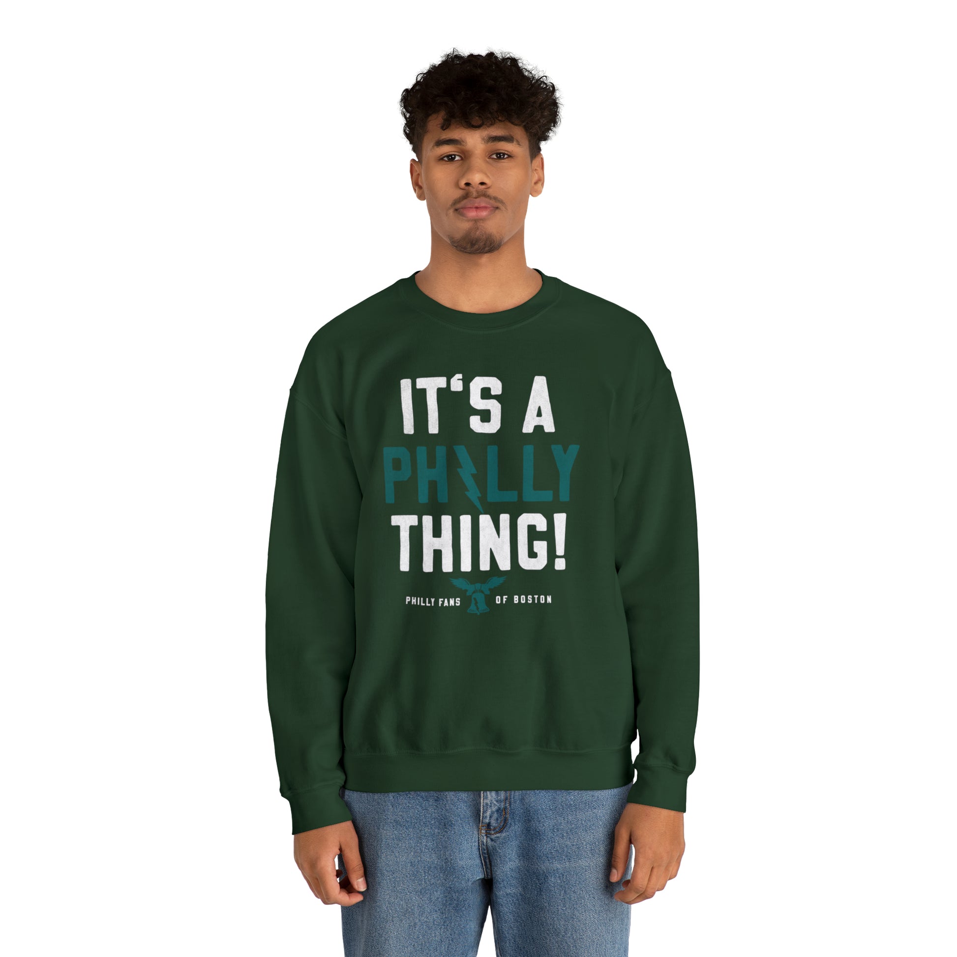 Man wearing a forest green heavy blend crewneck sweatshirt with white and teal It's a Philly Thing graphic print.