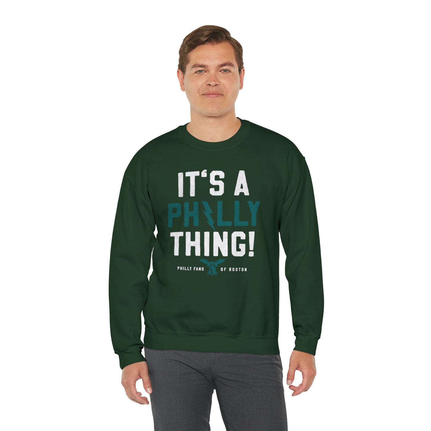 Man wearing a dark green heavy blend crewneck sweatshirt with It's a Philly Thing graphic print.