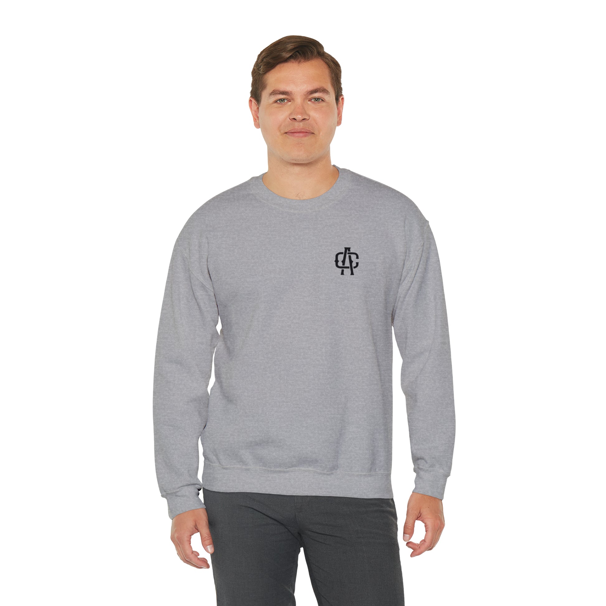 Man wearing a grey heavy blend crewneck sweatshirt with a small black logo on the left chest.