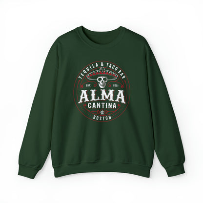 Dark green crewneck sweatshirt featuring a circular Alma Cantina logo with a skull wearing a sombrero.