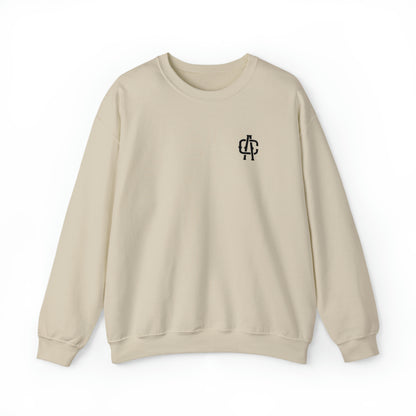Sand-colored heavy blend crewneck sweatshirt with a black monogram logo on the left chest.