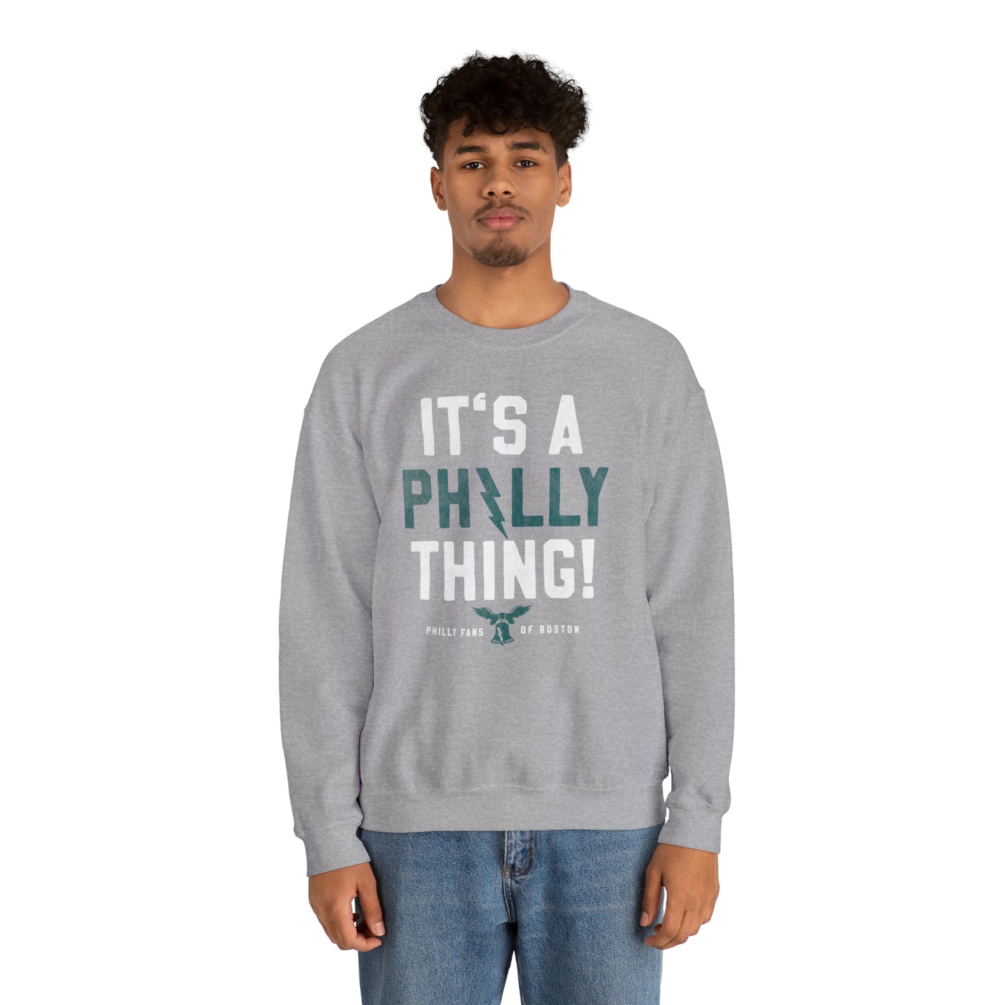 Man wearing a grey heavy blend crewneck sweatshirt with It's A Philly Thing text graphic.