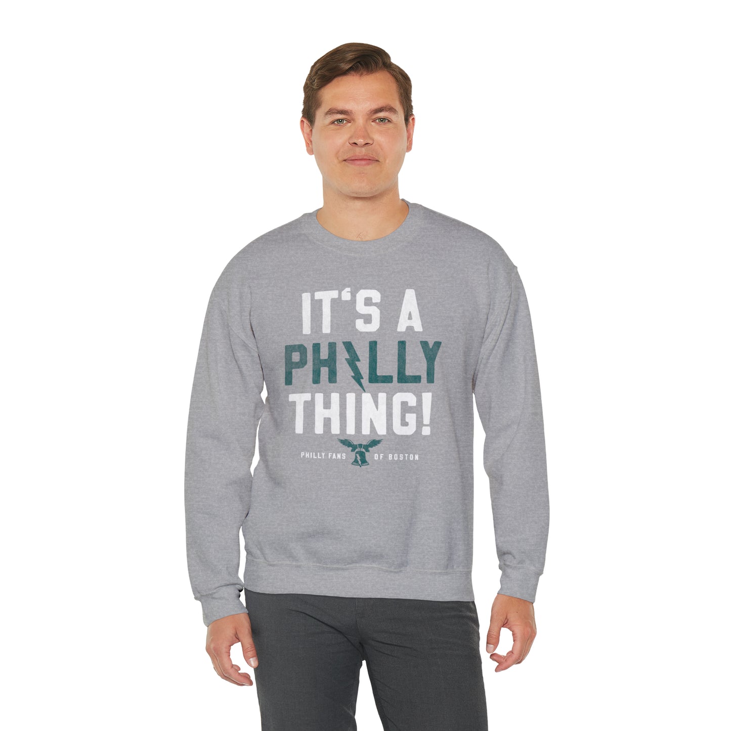 Man wearing a grey heavy blend crewneck sweatshirt with It's A Philly Thing graphic print.
