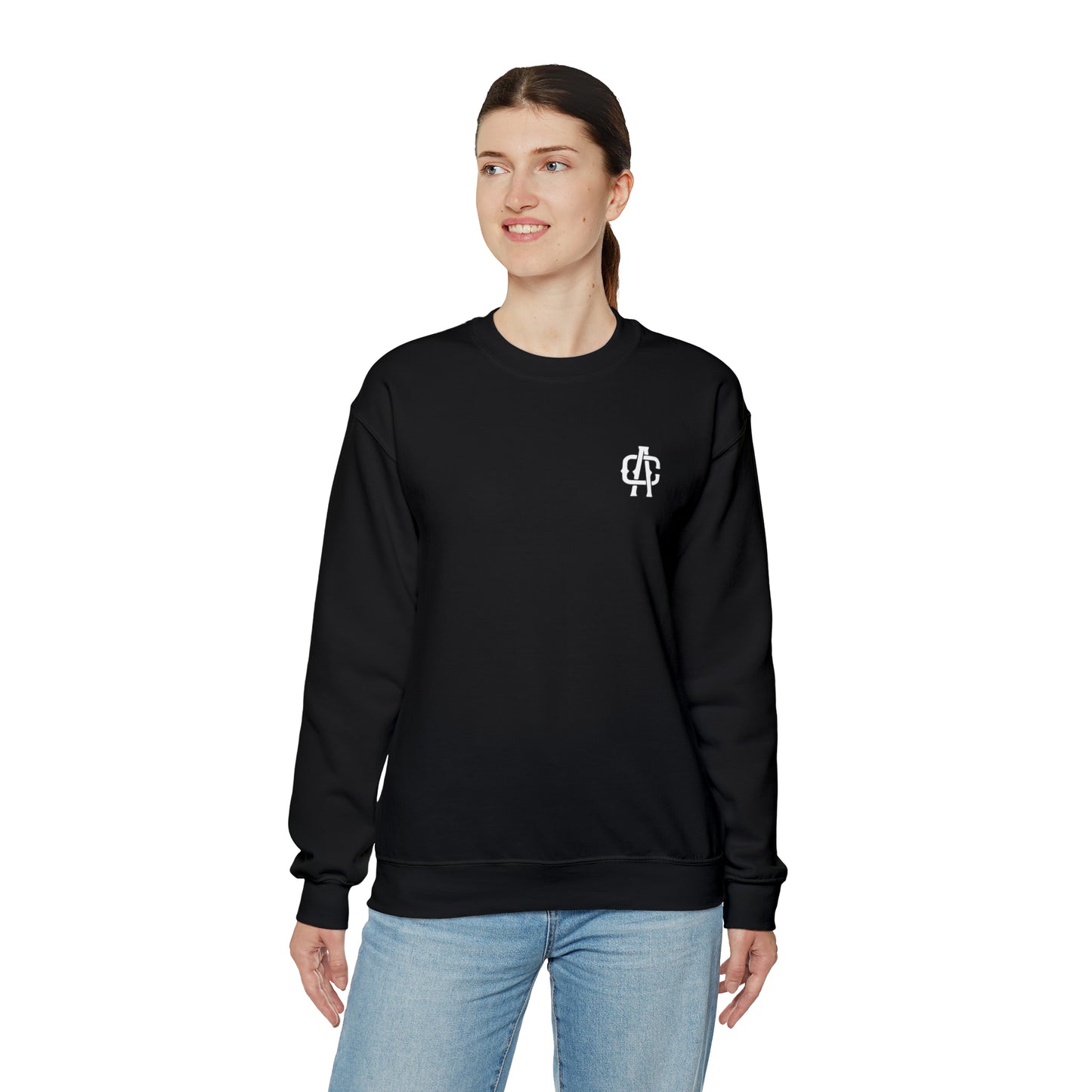 Woman wearing a black heavy blend crewneck sweatshirt with a small white logo on the chest, isolated on white.