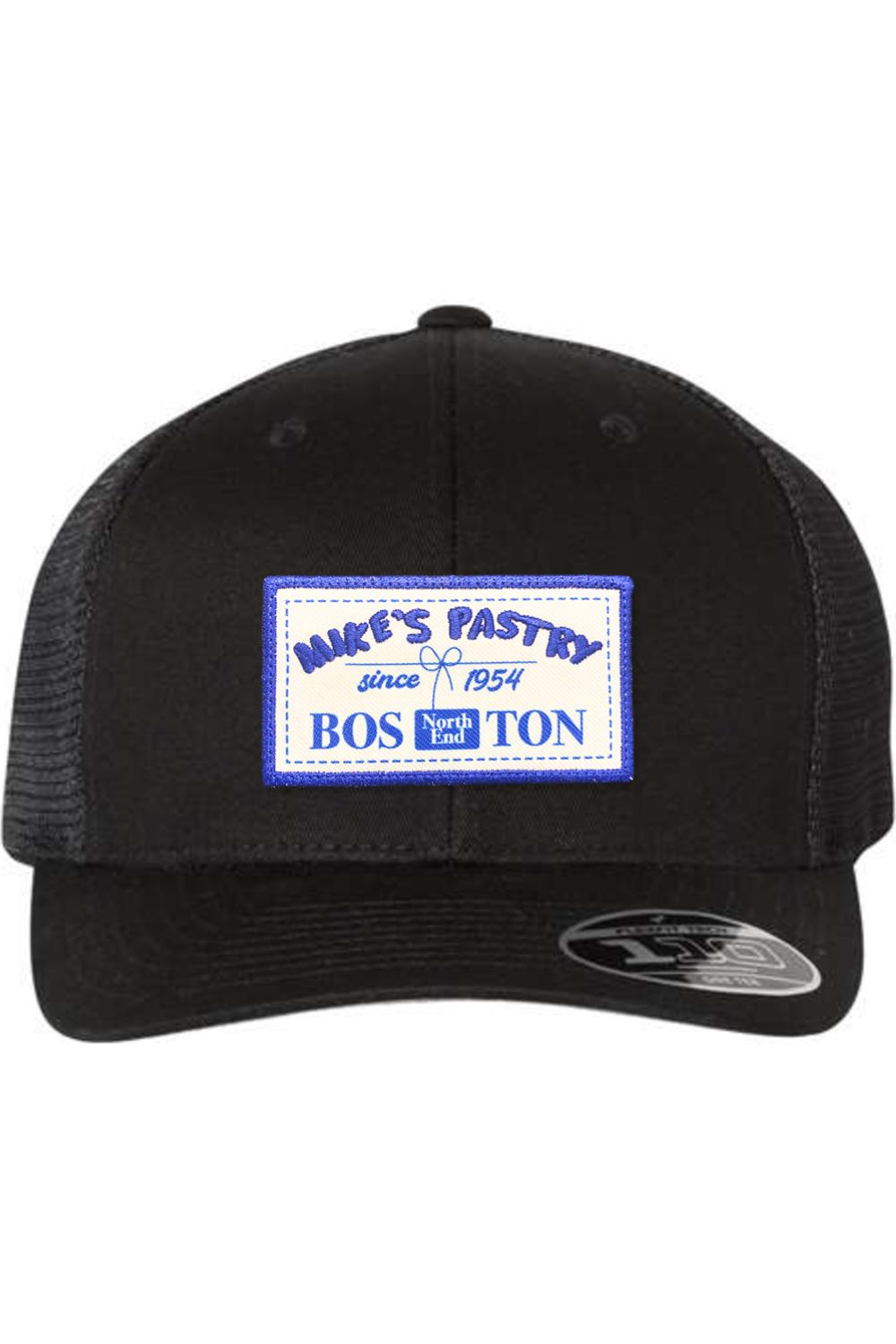 Black Mike's Pastry Flexfit 110 mesh-back cap with a blue and white rectangular logo patch on the front.