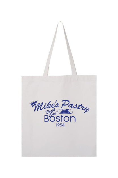 White canvas tote bag featuring a blue Mike's Pastry North End Boston logo with a cannoli graphic.