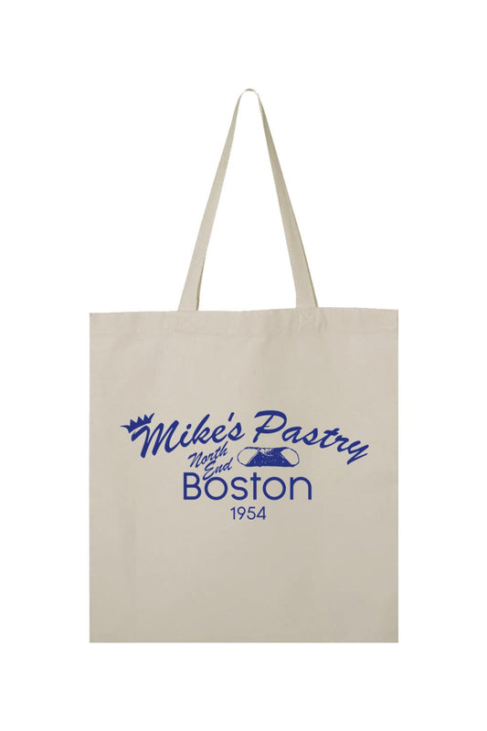 Beige canvas tote bag featuring a blue Mike's Pastry North End Boston logo with a cannoli graphic.