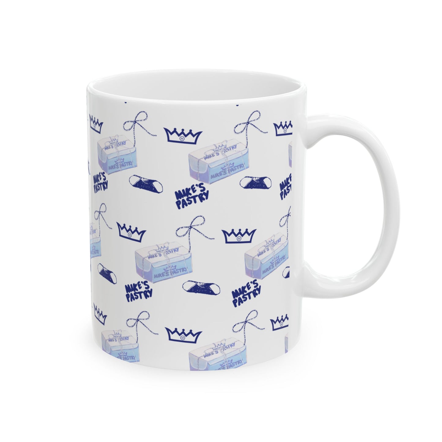 11oz white ceramic mug featuring a blue Mike's Pastry box, crown, and cannoli pattern with a comfortable C-handle.