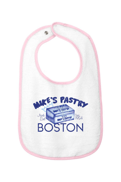 White cotton terry baby bib with pink trim, featuring a blue Mike's Pastry Boston box graphic and hook-and-loop closure.