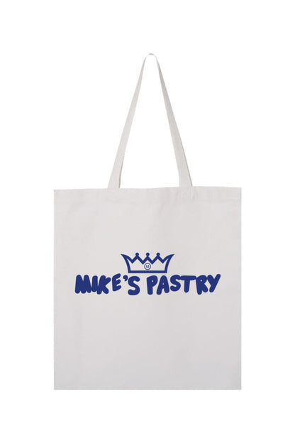 White canvas tote bag featuring a blue Mike's Pastry logo with a crown icon and bold lettering.