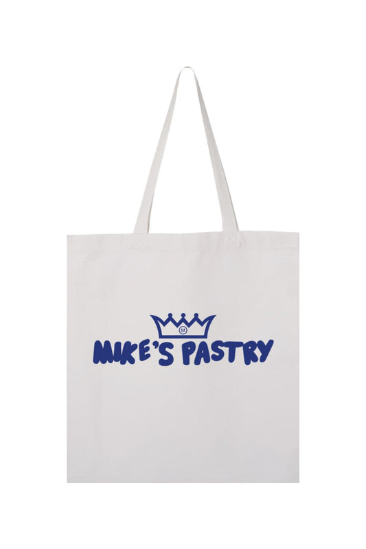 White canvas tote bag featuring a blue Mike's Pastry logo with a crown icon and bold lettering.