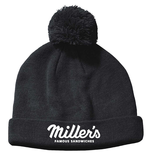 Black acrylic knit cuffed beanie with a top pom-pom and white Miller's Famous Sandwiches logo embroidery.