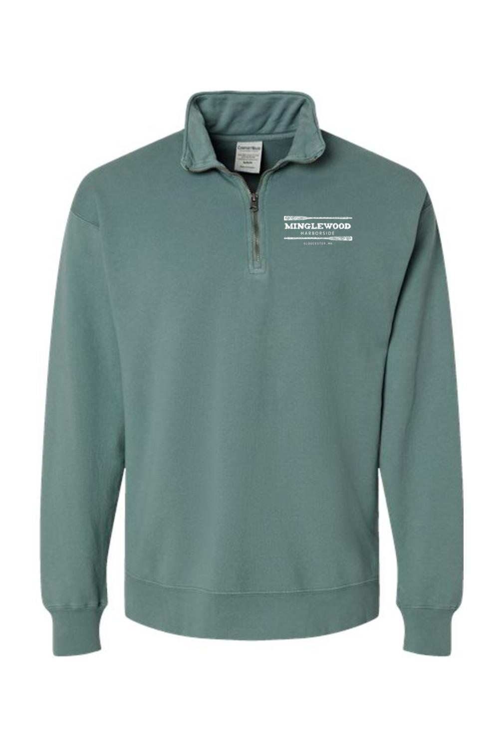 Sage green garment-dyed men's quarter-zip sweatshirt with a white Minglewood Harborside logo on the chest.
