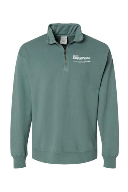Sage green garment-dyed men's quarter-zip sweatshirt with a white Minglewood Harborside logo on the chest.