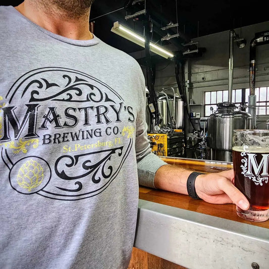 Grey unisex long sleeve shirt featuring the Mastry’s Brewing Co. logo in black and yellow on a soft cotton-blend fabric.