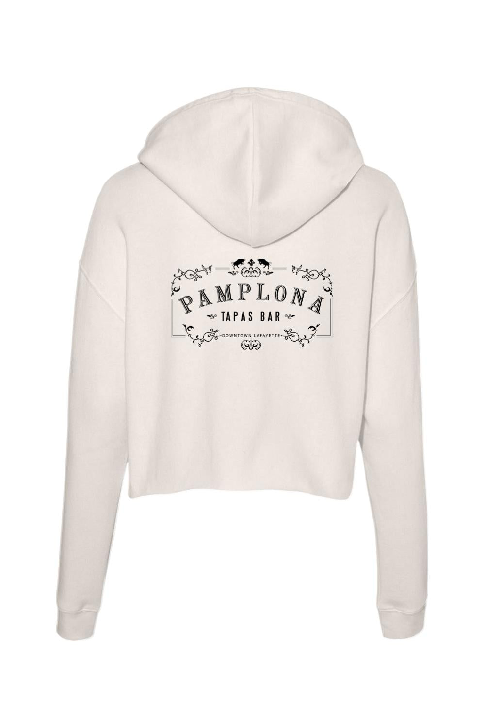 Cream-colored cropped athletic hoodie featuring a black Pamplona Tapas Bar logo graphic on the back.