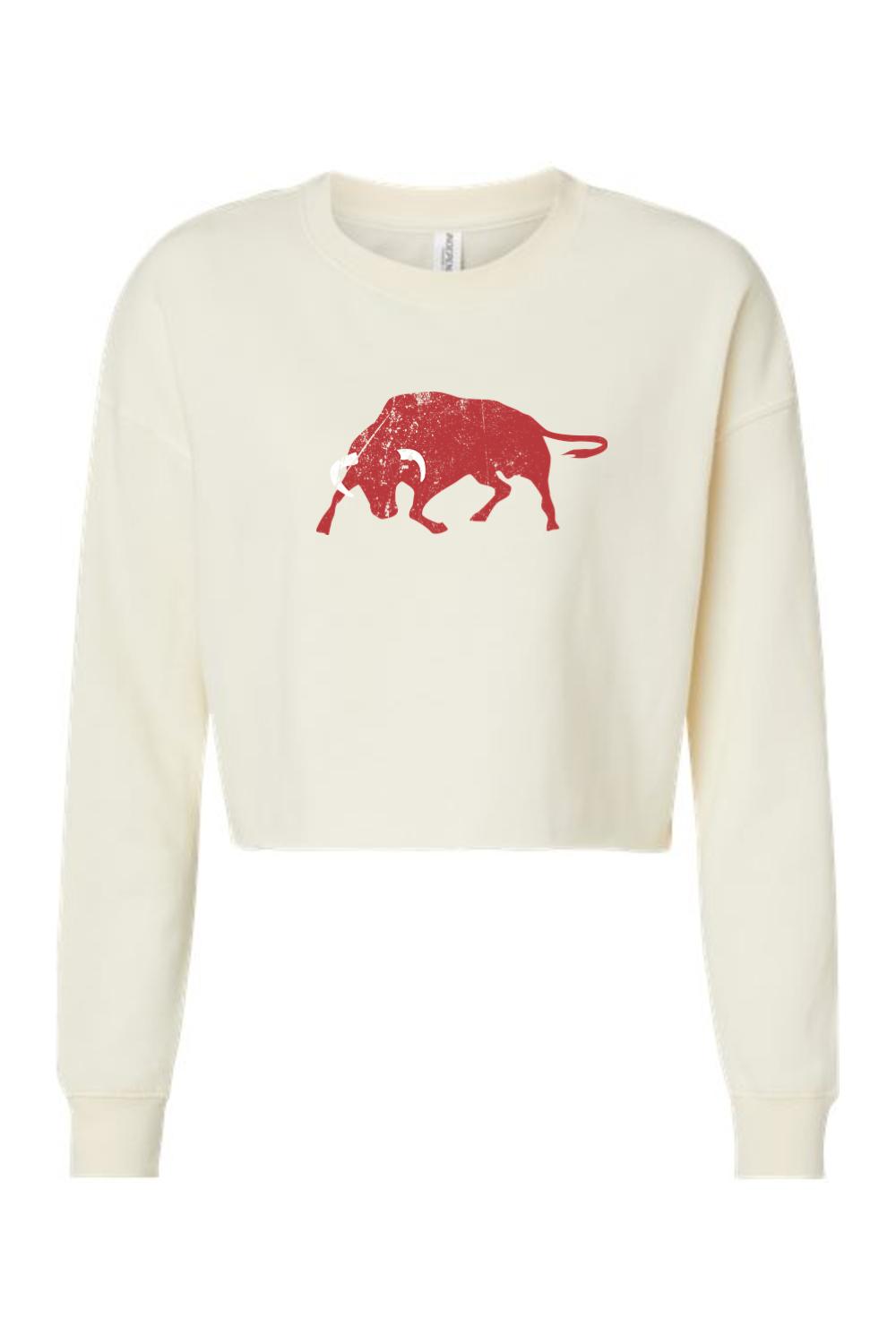 Cream-colored cropped crewneck sweatshirt featuring a distressed red bull graphic on the chest.