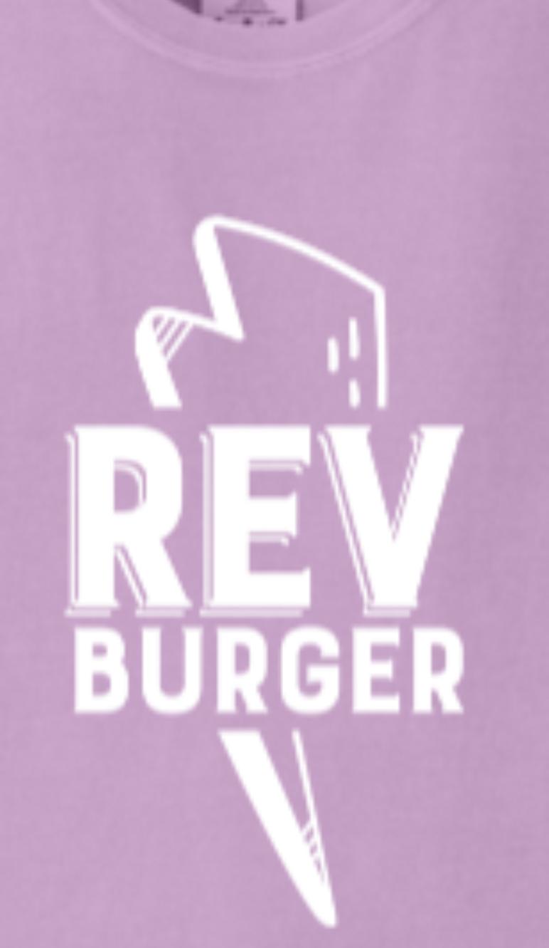 Light purple Comfort Colors cotton t-shirt featuring a white Rev Burger logo with a lightning bolt graphic.