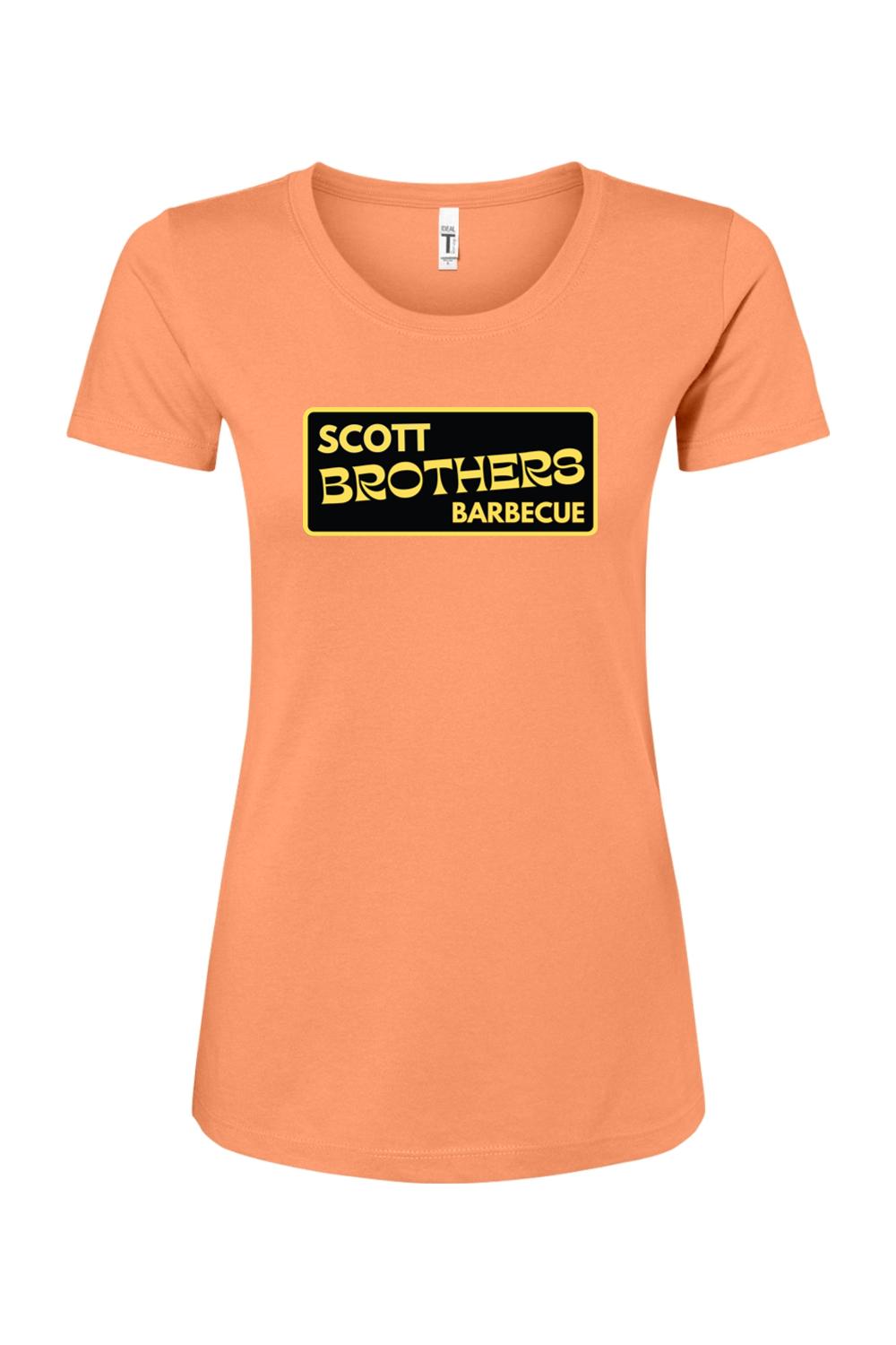 Women's peach-colored cotton-blend t-shirt featuring a black and gold Scott Brothers Barbecue logo on the chest.