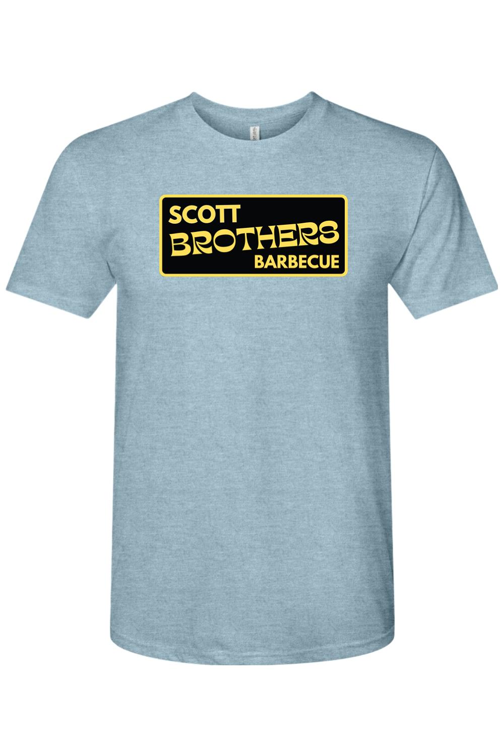 Light blue heathered triblend t-shirt featuring a black and gold Scott Brothers Barbecue logo on the chest.