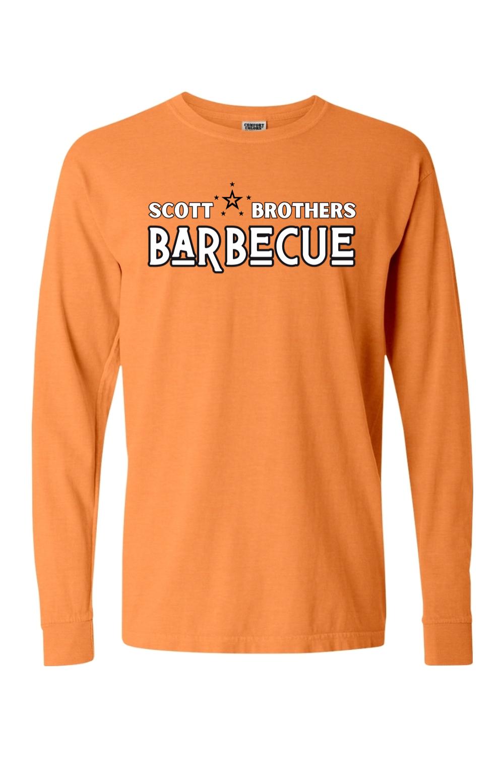 Orange Comfort Colors long sleeve t-shirt featuring a black and white Scott Brothers Barbecue logo on the chest.