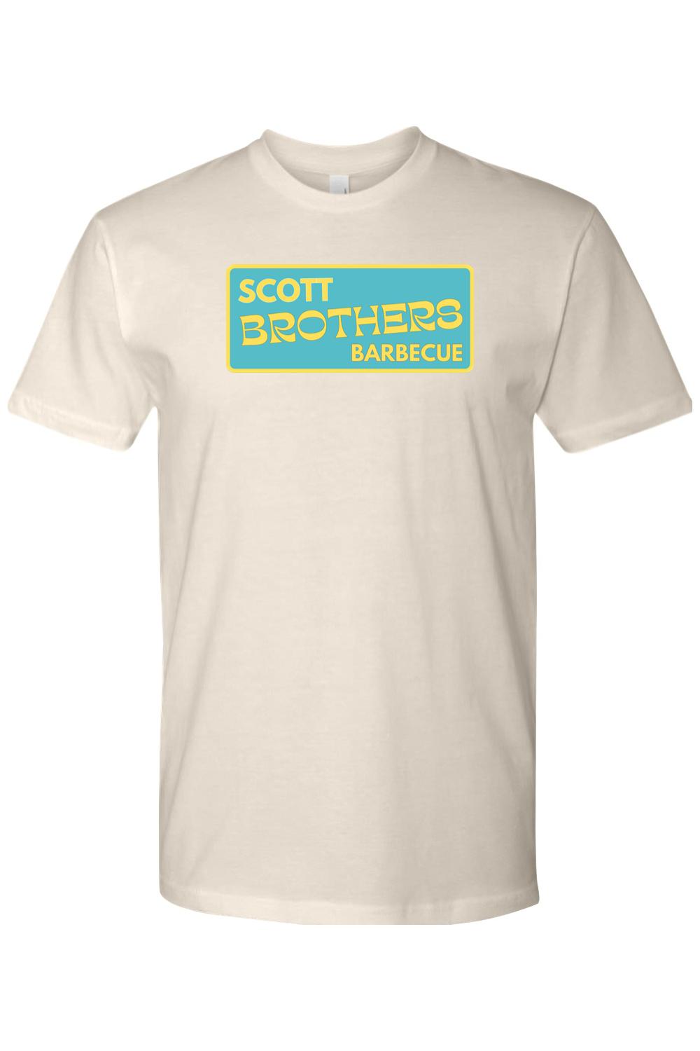 Off-white cotton t-shirt featuring a rectangular teal logo with yellow Scott Brothers Barbecue text.