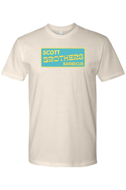 Off-white cotton t-shirt featuring a rectangular teal logo with yellow Scott Brothers Barbecue text.