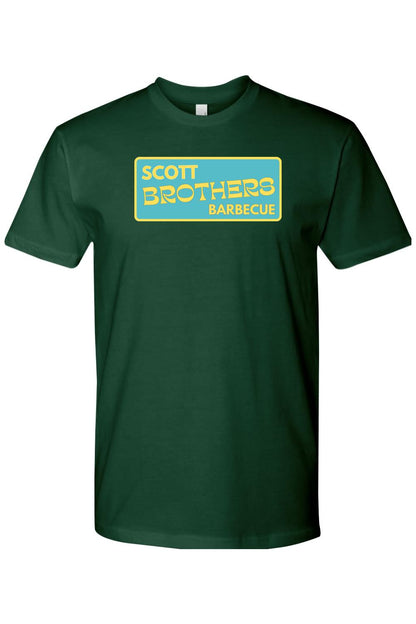 Dark green cotton t-shirt with a yellow and teal Scott Brothers Barbecue logo graphic on the chest.