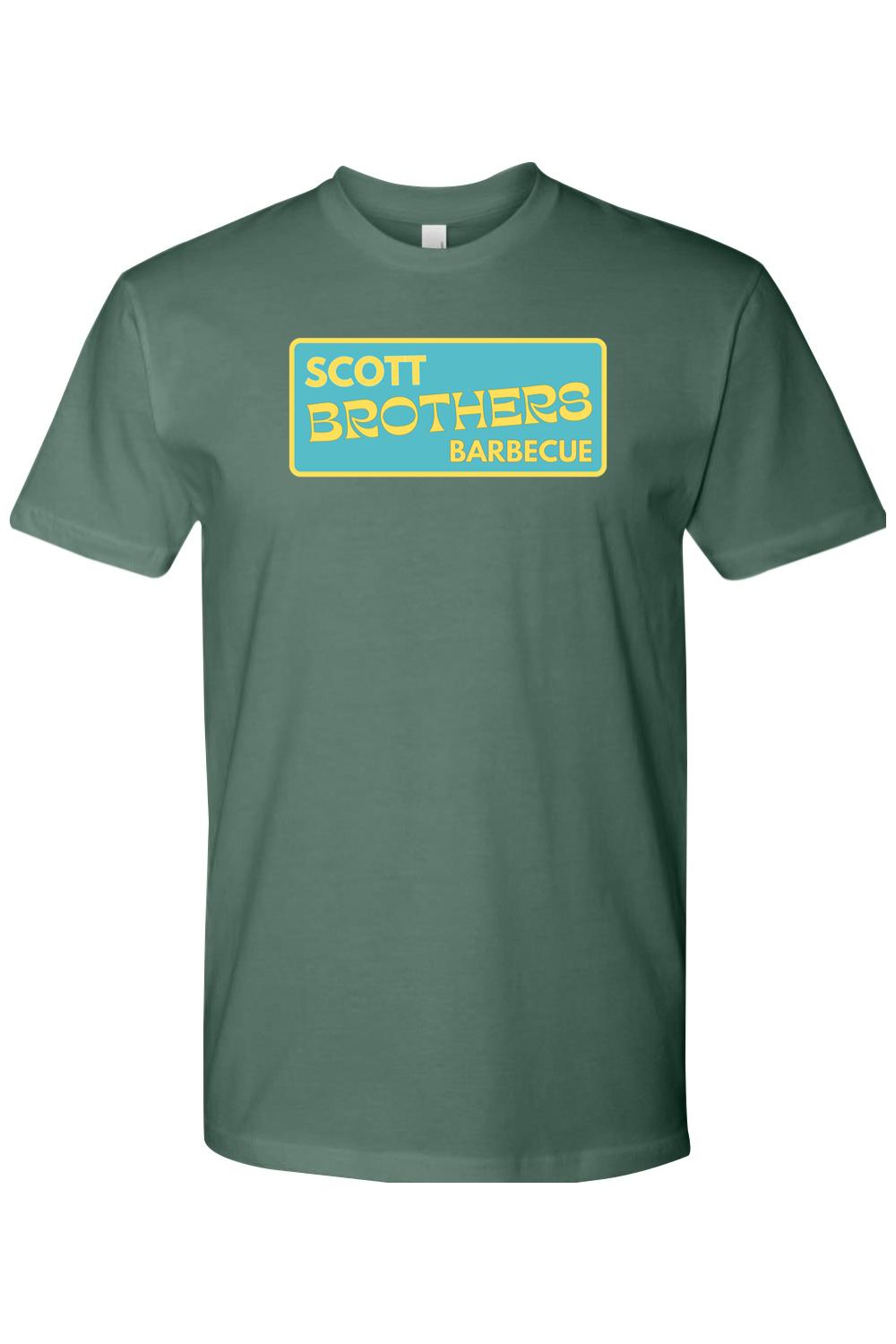 Dark green cotton t-shirt featuring a yellow and teal Scott Brothers Barbecue logo on the chest.