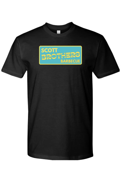 Black cotton t-shirt featuring a yellow and teal Scott Brothers Barbecue logo on the chest.