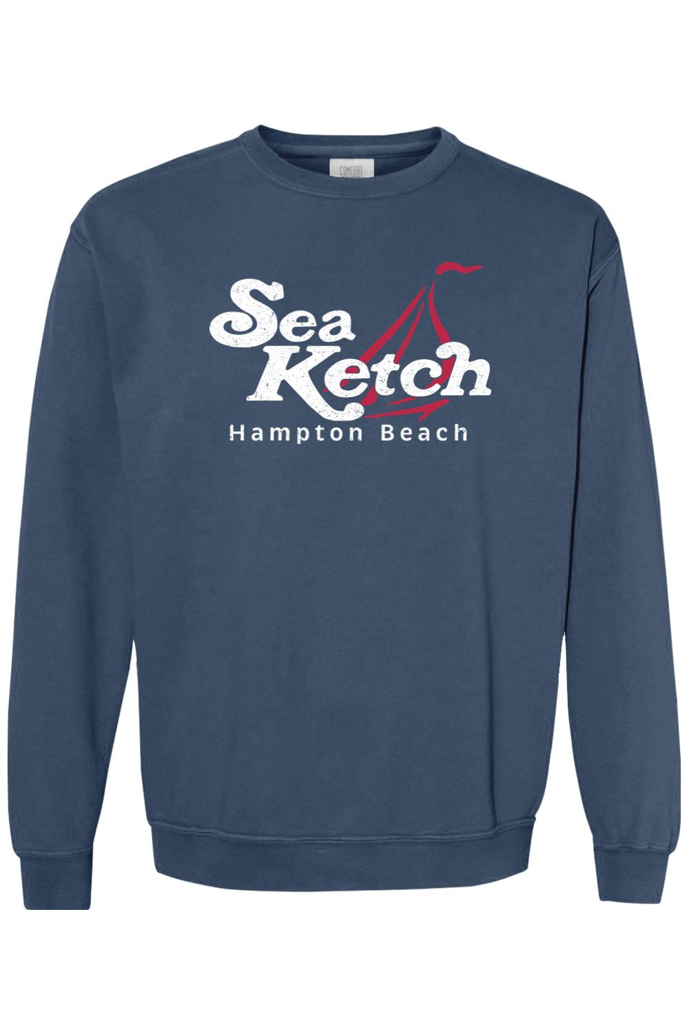 Blue Comfort Colors crewneck sweatshirt featuring a white Sea Ketch Hampton Beach graphic with a red sailboat design.