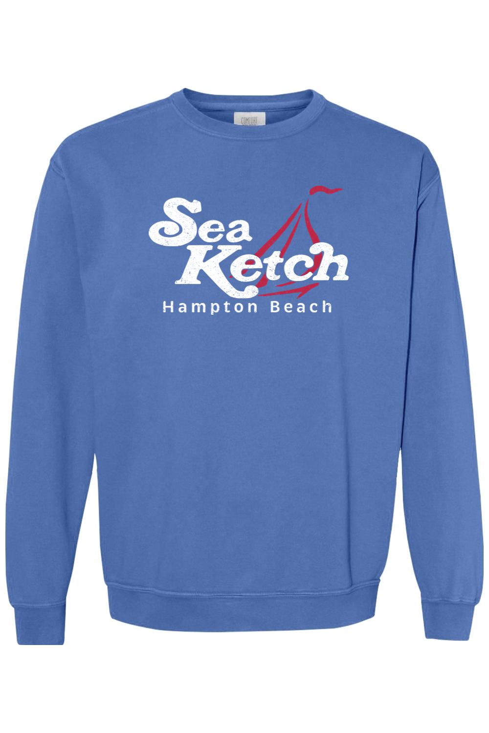 Blue Comfort Colors crewneck sweatshirt featuring a white Sea Ketch Hampton Beach graphic with a red sailboat icon.