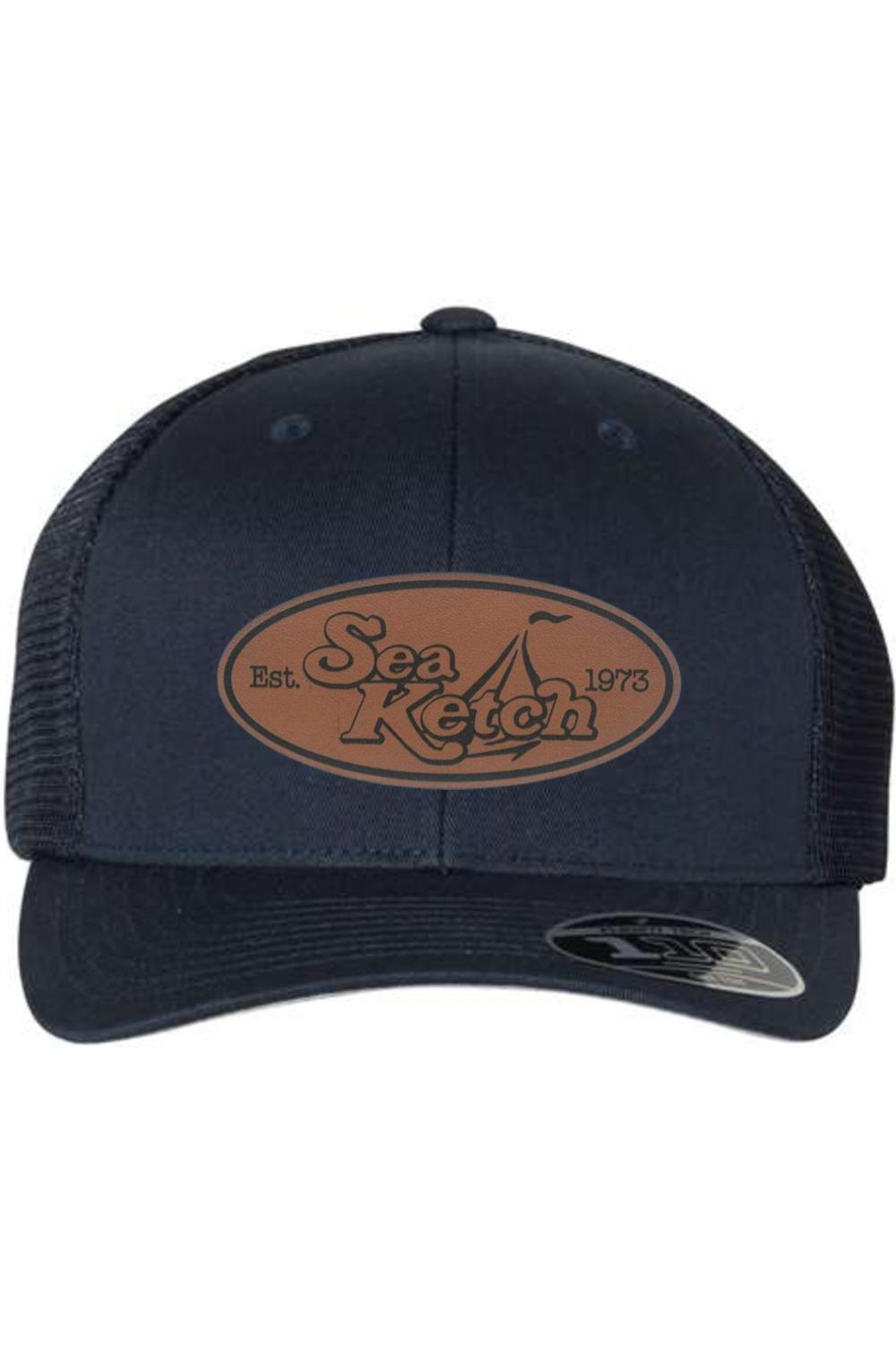 Navy blue Flexfit 110 trucker cap with a brown leather patch featuring the Sea Ketch logo and mesh back.