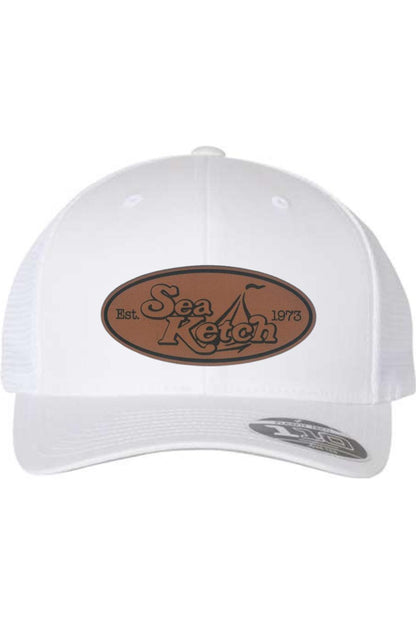 White Flexfit 110 trucker cap with a brown oval leather patch featuring the Sea Ketch logo and mesh back.