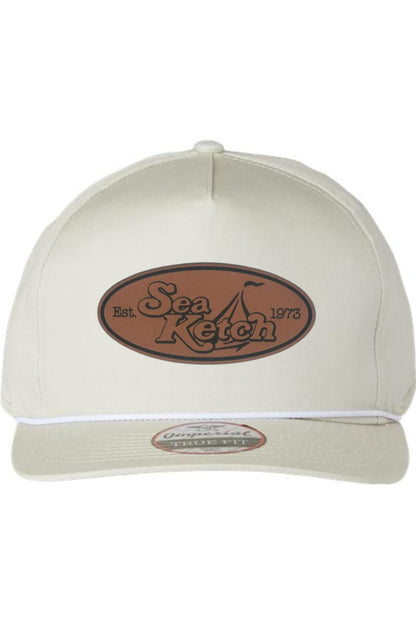 Off-white cotton twill five-panel hat with a brown leather Sea Ketch patch and a decorative white front rope.