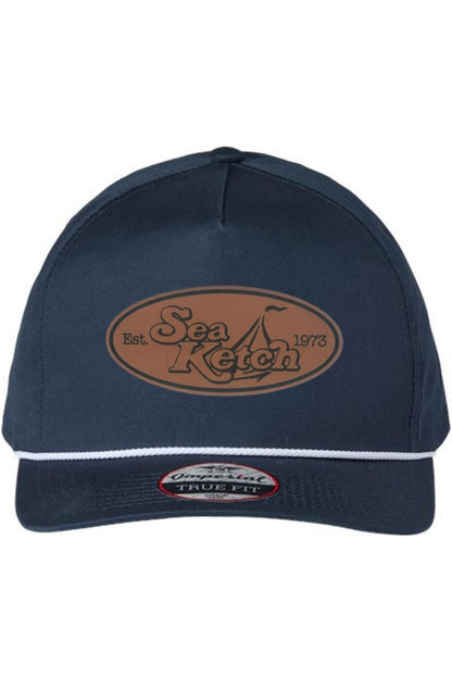 Navy blue cotton twill five-panel hat with a white rope trim and oval Sea Ketch leather patch on the front.