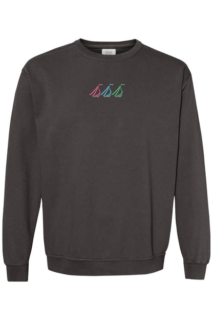 Charcoal grey Comfort Colors crewneck sweatshirt featuring a small, colorful tri-sail graphic on the chest.