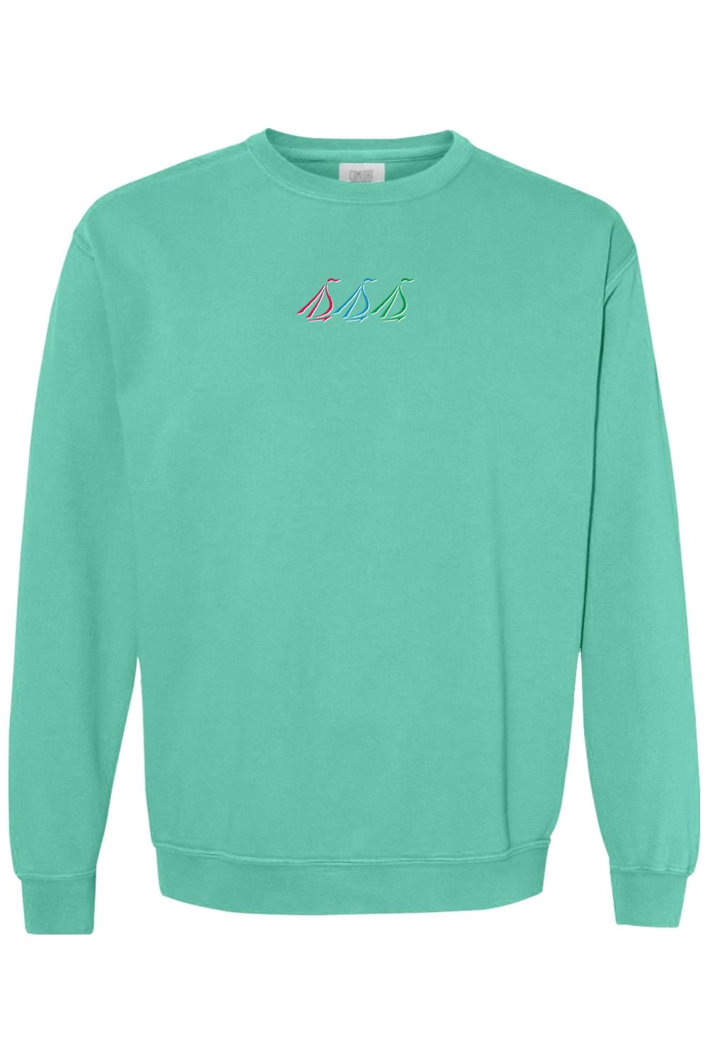 Mint green Comfort Colors crewneck sweatshirt featuring a small, colorful embroidered tri-sail nautical design.