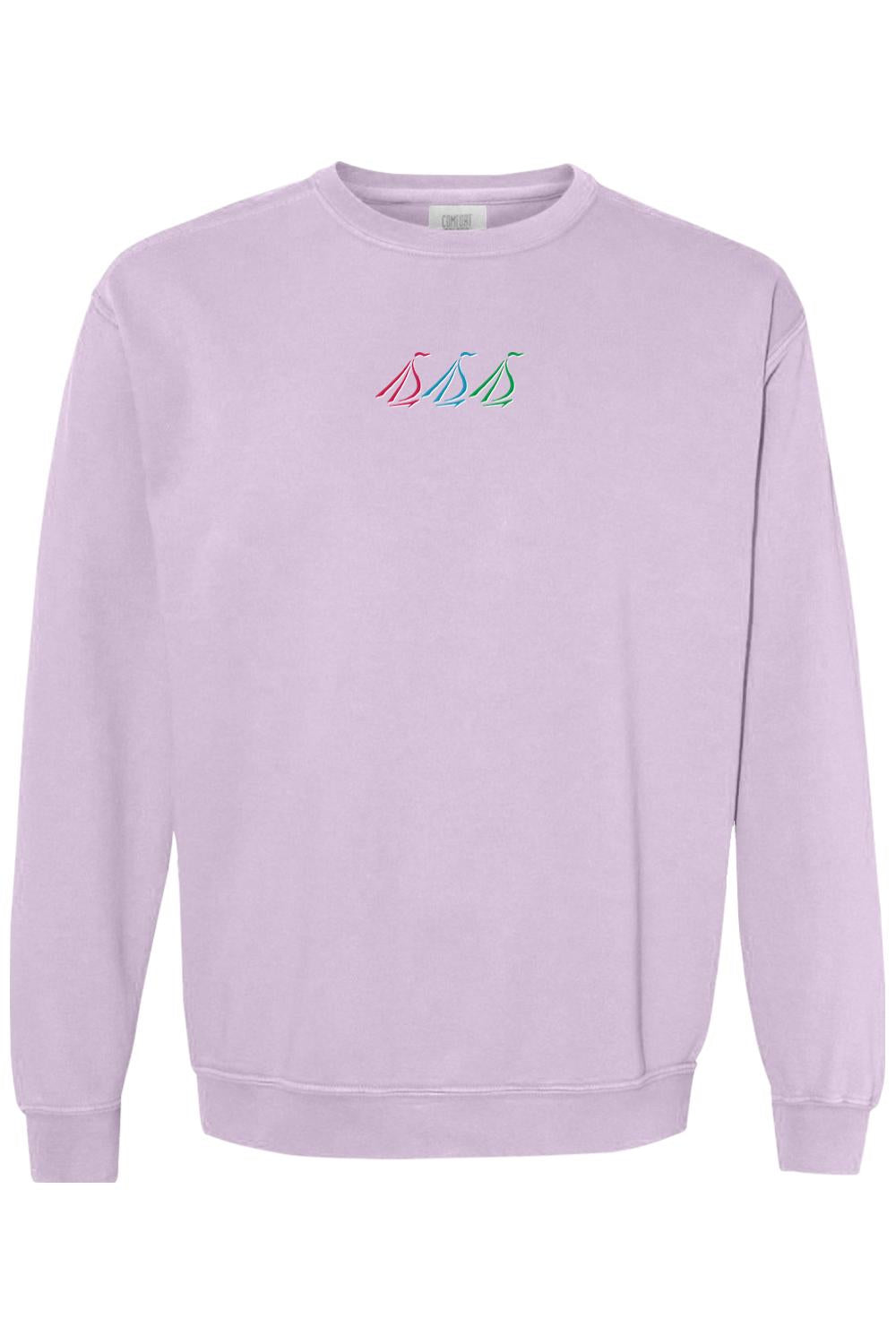 Light purple Comfort Colors crewneck sweatshirt featuring a small, colorful tri-sail nautical logo on the chest.