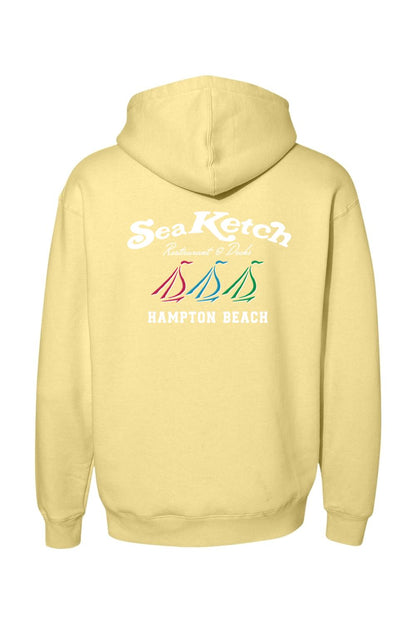 Pale yellow heavyweight hoodie featuring a Sea Ketch Hampton Beach logo with three colorful sailboats on the back.