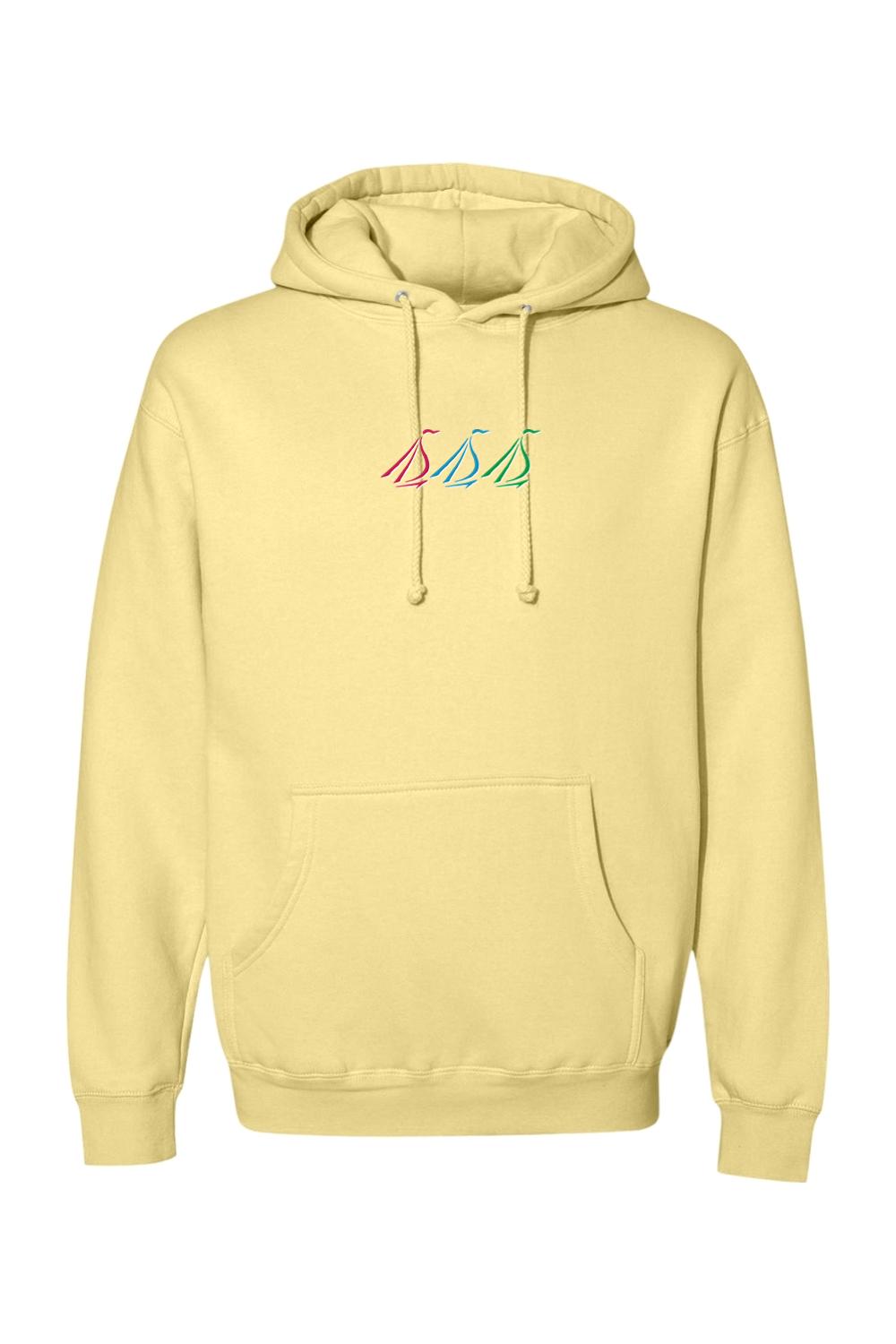Pale yellow heavyweight hoodie with a small, colorful tri-sail graphic on the chest and a front kangaroo pocket.