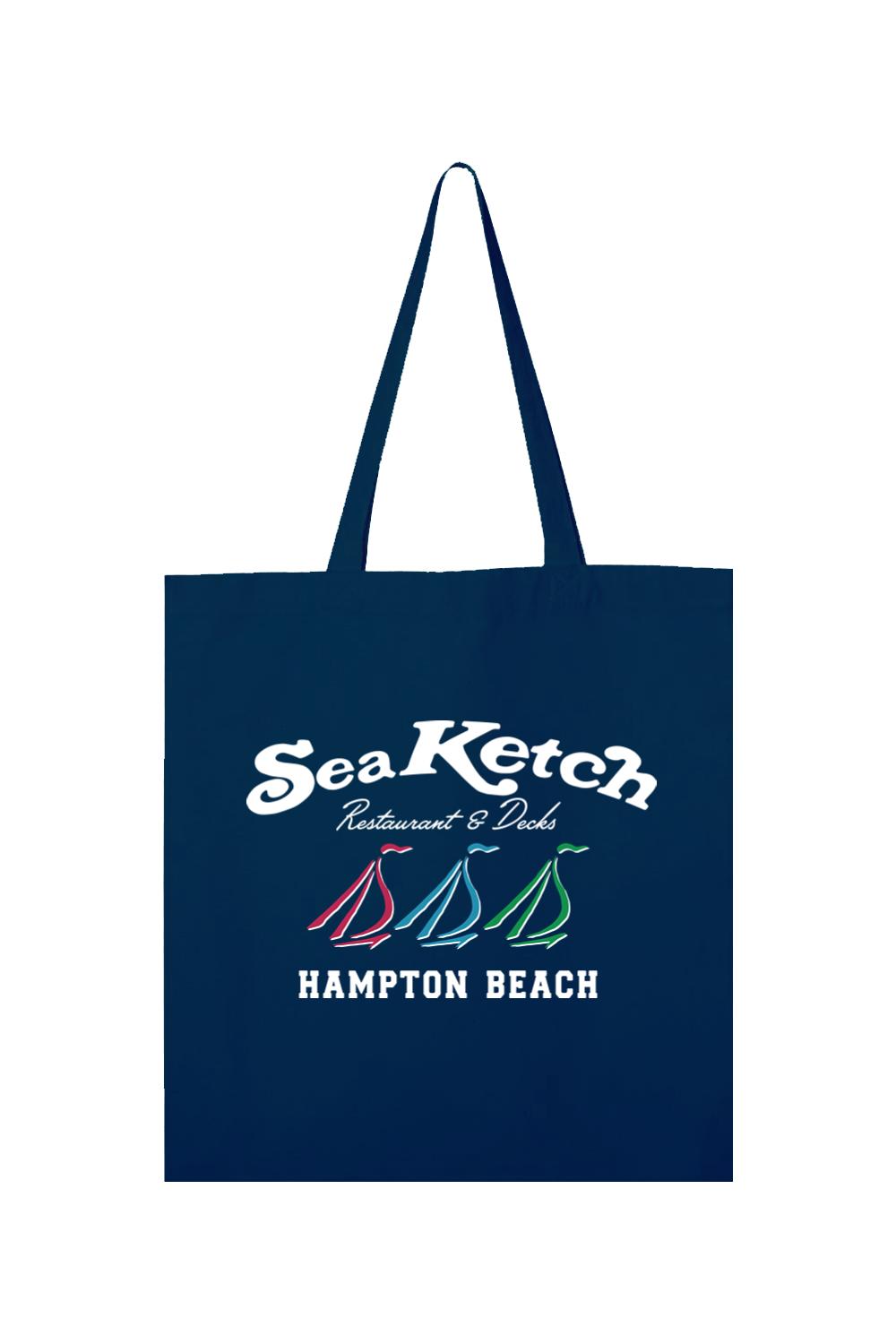Navy blue canvas tote bag featuring a white Sea Ketch Hampton Beach logo with three colorful sailboat icons.