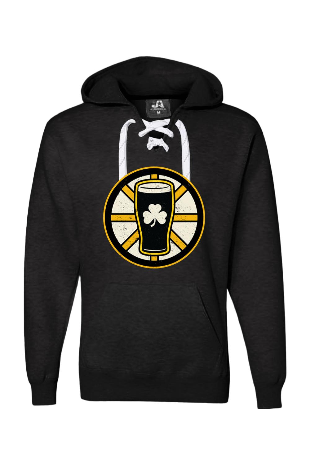 Black lace-up hockey hoodie featuring a gold and black beer pint graphic with a white shamrock on the front.