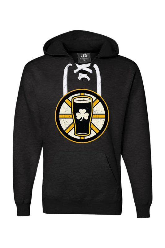 Black lace-up hockey hoodie featuring a gold and black beer pint graphic with a white shamrock on the front.